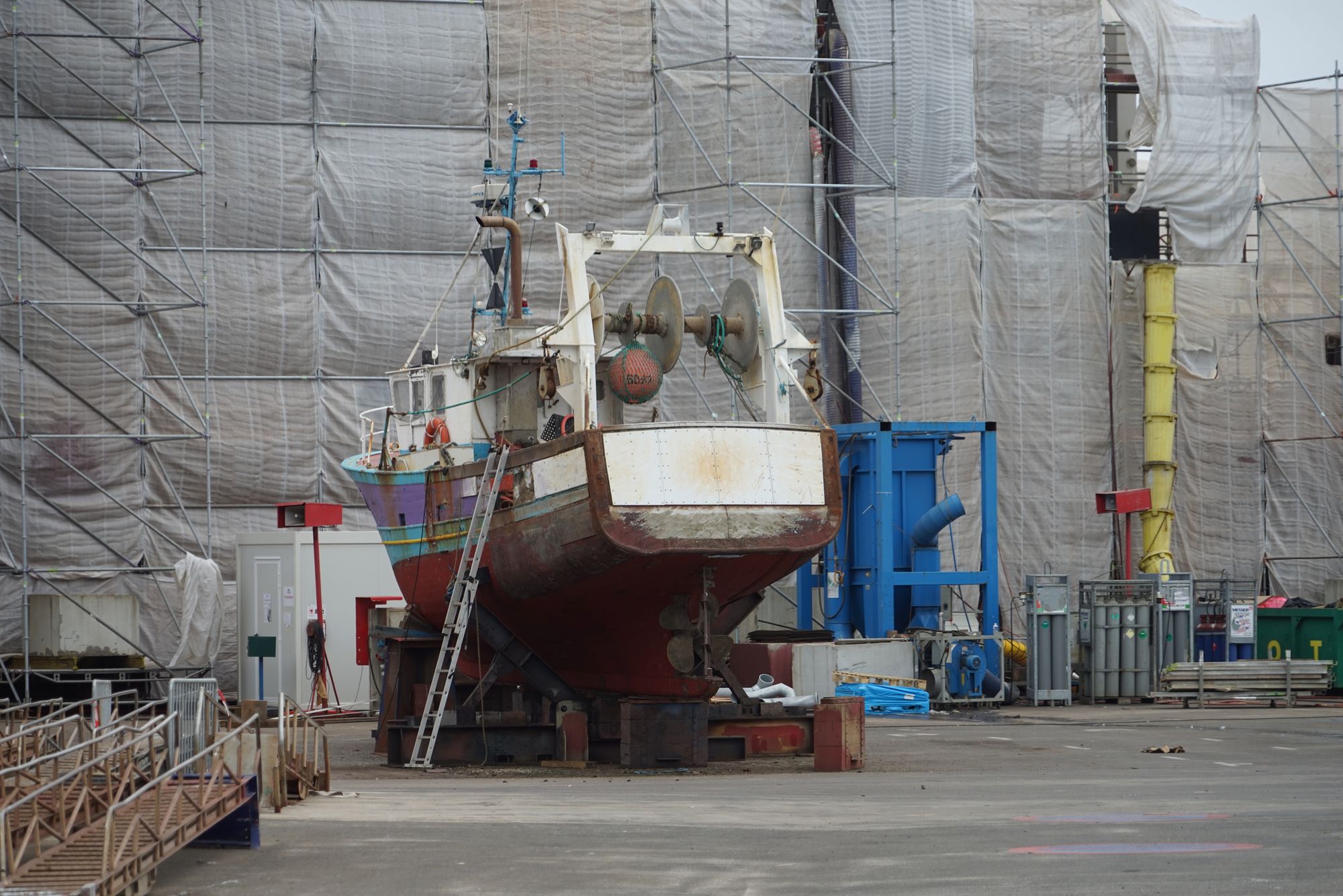 Vessel undergoing maintenance work in a professional shipyard