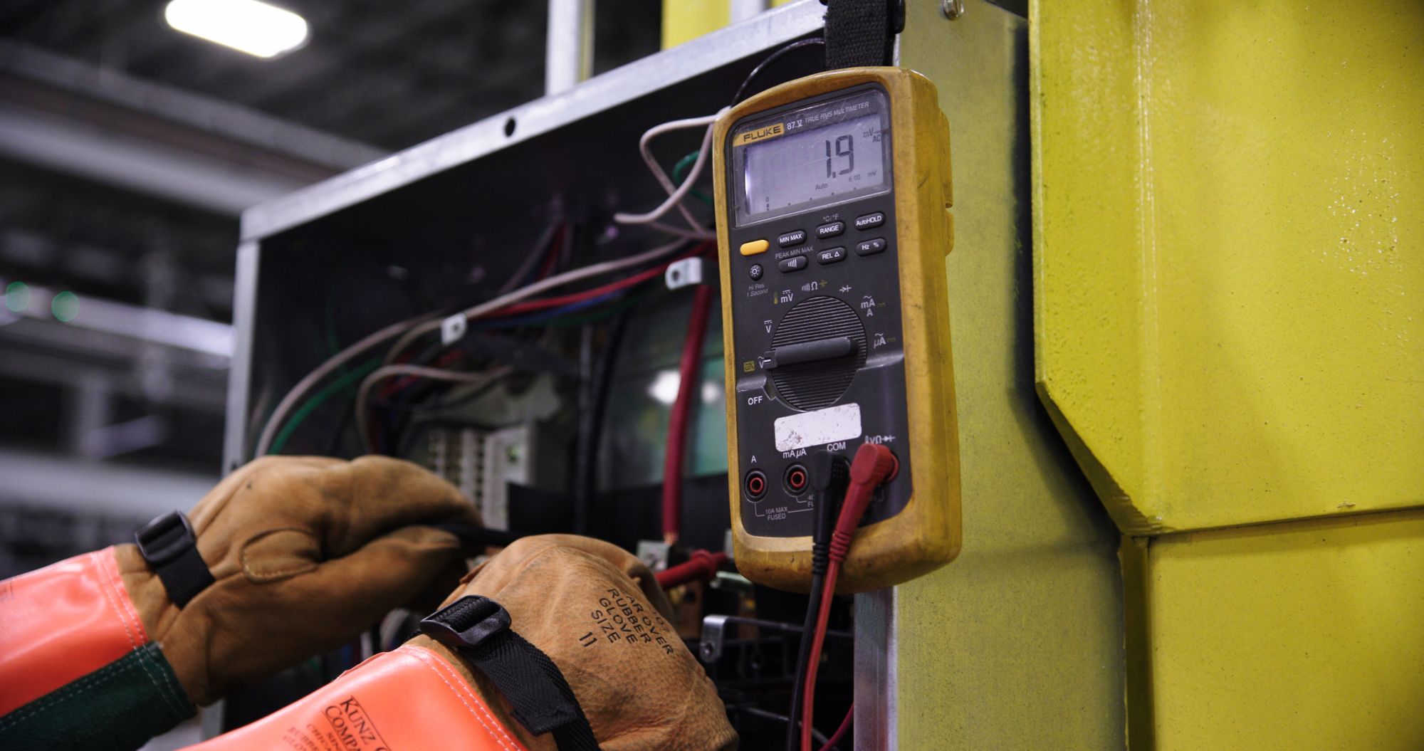 Technician testing an industrial electrical control system