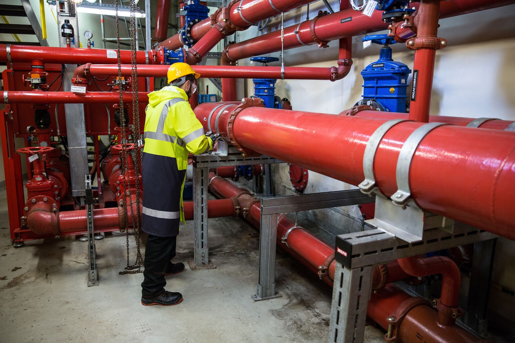 Engineer inspecting an industrial marine piping system
