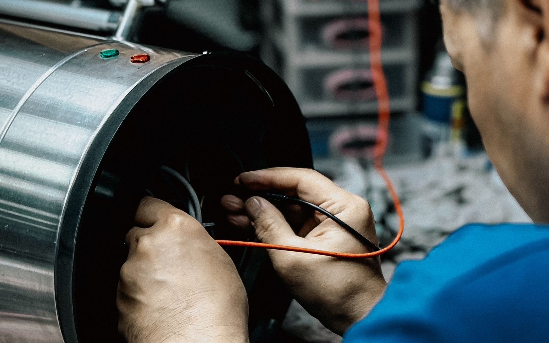 Technician testing and repairing industrial electrical equipment